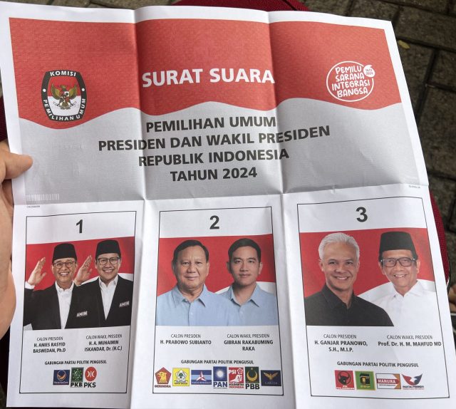 2024 Indonesian presidential election Indonesian voters cast their ballots at a polling station during the 2024 presidential election, with election officials observing the process.