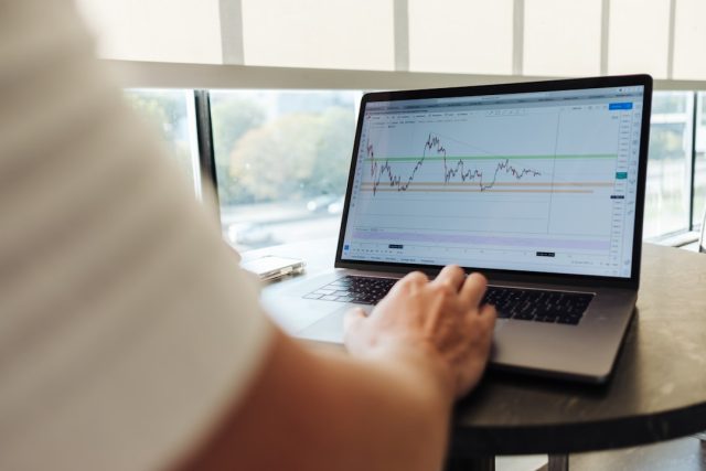 Reuters Poll: 31 of 41 Economists Say Global Market in Recession Economists reviewing data charts as coronavirus pandemic triggers global market recession
