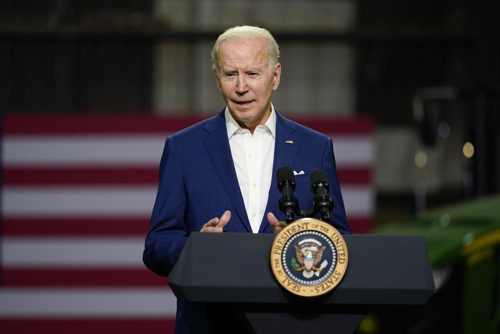Biden speaking at a podium outdoors President Joe Biden speaks at a podium in Menlo, Iowa, announcing an ethanol rule waiver to reduce gasoline prices.