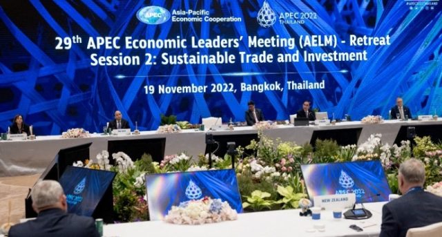 Apec Bangkok Summit Leaders Meeting Asia-Pacific leaders gather at a summit table in Bangkok, with national flags displayed behind them.