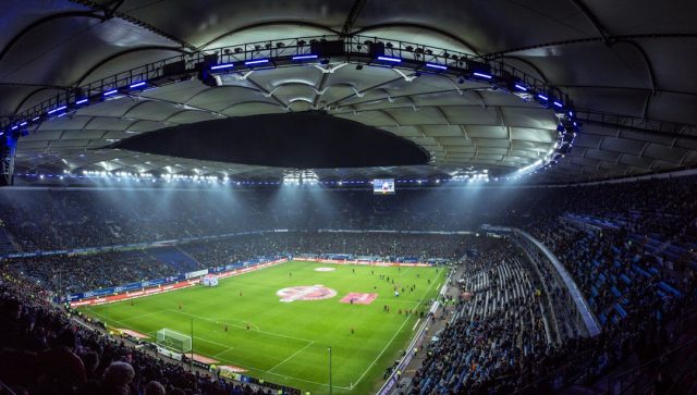 Leipzig Hosts First Major Football Tournament in Former East Germany Fans waving flags fill the stands of Leipzig's stadium during a UEFA Euro 2024 match.