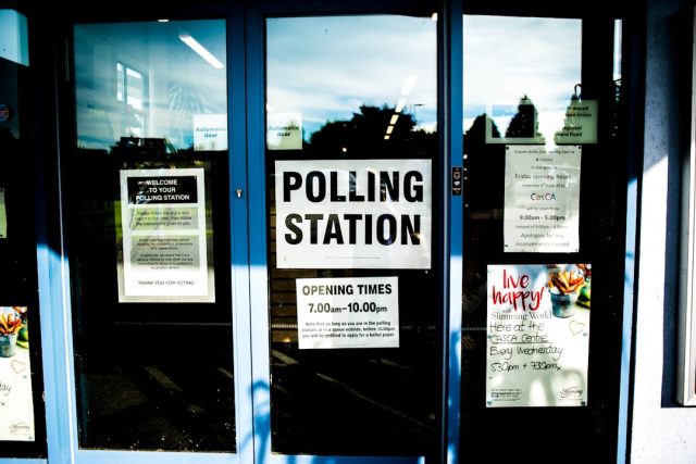 South Africa's ANC Faces First Loss of Parliamentary Majority in 2024 Vote Voters queue at a polling station in South Africa during the 2024 general election, with ANC campaign posters in the background.