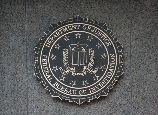 FBI Releases Single Document Detailing 2023 Sighting of Bronze Object Close-up of an FBI 302 form with the word bronze visible beside black redaction boxes on a desk under a desk lamp.