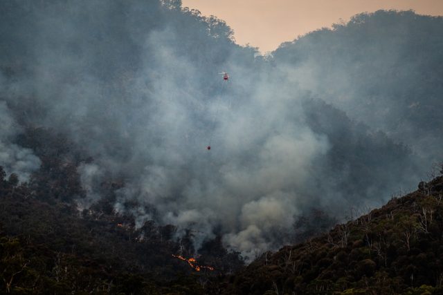 Fact-checkers debunk persistent directed-energy weapon claims in LA fires Smoke rises over a Los Angeles neighborhood as residents survey fire damage and ash-covered debris.
