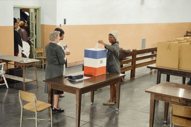 New Mexico Election Results Signal Test for Federal Land and Energy Policies Voters cast ballots at a polling station in New Mexico on election day, with signs of energy and land policy debates in the background.