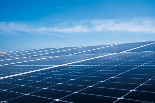 Talatan Solar Park's 21-Gigawatt Output Powers Millions of Homes Annually Vast array of solar panels stretching across the Tibetan Plateau under clear blue skies near Longyangxia Dam.