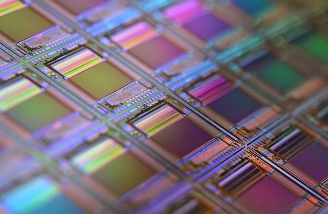 Apple M4's System-on-Chip Design Signals End of One-Size-Fits-All Processors Apple M4 chip on a circuit board with integrated CPU, GPU, NPU, and DSP units visible under a microscope.