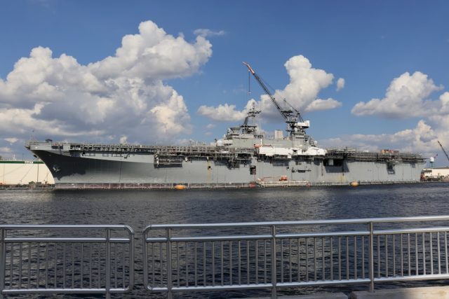 Iranian Frigate Sahand Capsizes Amid Navy's Push for Power Projection The capsized Iranian frigate Sahand lies on its side at a crowded Bandar Abbas naval dock, cranes looming over the wreck.