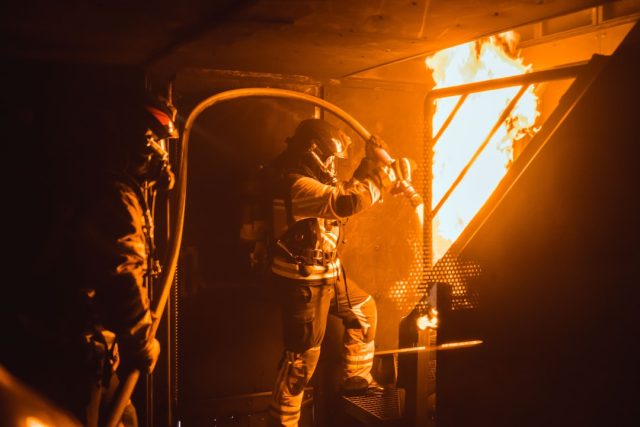 Manila Fire Highlights Deadly Risk of Narrow Streets for Emergency Access Firefighters battle a blaze in a narrow Manila alley as smoke billows from a residential-commercial building.