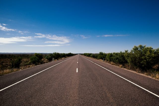 Head-On Crash in Gqeberha Kills Seven, Raises Road Safety Questions A mangled car and truck wreckage on a Gqeberha road after a head-on collision, with emergency responders assessing the scene.