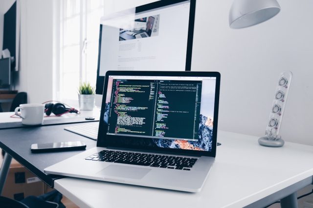 Meta Open-Sources Code Llama, Three Sizes for Developer Hardware Meta's Code Llama coding AI model displayed on a laptop screen with developer code in the background.