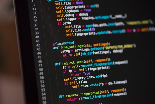 Stability AI's Stable Diffusion 3 Improves Text Rendering and Image Quality Stability AI logo displayed on a digital screen with abstract AI-generated images in the background.