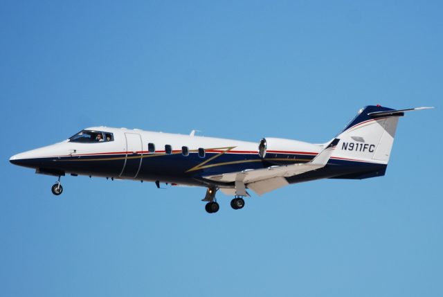 Learjet Air Ambulance Crashes in Philadelphia, Killing Seven, Injuring Nineteen Emergency responders at the scene of a Learjet 55 crash in a Philadelphia neighborhood, with damaged homes and debris visible.