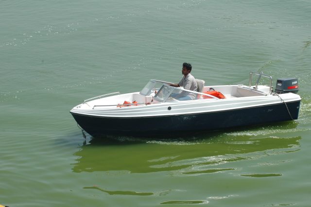 Boat Collision on Alabama Lake Kills Three During Fishing Tournament Two damaged boats on Lewis Smith Lake after a collision during a fishing tournament, with emergency responders nearby.
