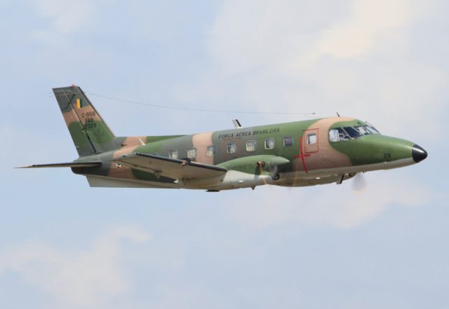Cargo Plane Wreckage Found in Haiti, Two Pilots Killed Wreckage of an Embraer EMB 110 Bandeirante aircraft scattered on a hillside in Jérémie, Haiti, with rescue personnel nearby.