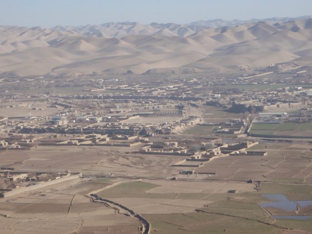 Bus Overturns in Afghanistan, Killing Nine and Injuring Thirty-Five An overturned passenger bus lies on a rural road in Badghis Province, Afghanistan, with emergency responders nearby.