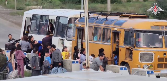 Expulsion of Nagorno-Karabakh Armenians Ethnic Armenian refugees flee Nagorno-Karabakh along a mountainous road, carrying belongings after Azerbaijan's military offensive.