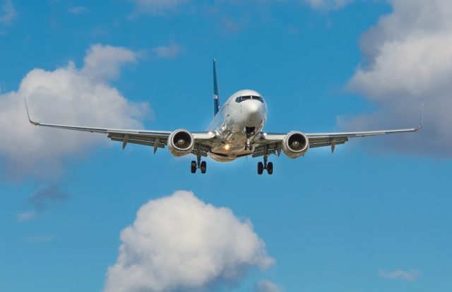 Flybe in emergency financing talks with UK government departments A Flybe regional aircraft parked at a British airport terminal with passengers boarding nearby.