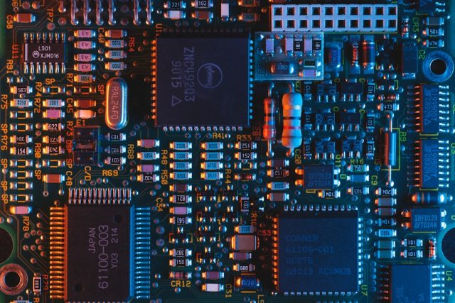 Foxconn in talks to acquire up to 30% stake in Malaysian chip firm DNeX Foxconn executives at a negotiating table with documents and a model of a semiconductor wafer