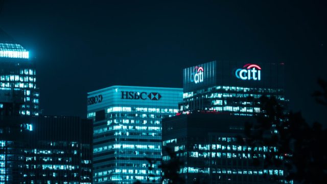 HSBC's China Expansion Stalls After Handing Huawei Files to US Prosecutors HSBC branch in Shanghai with security shutters half-closed, symbolizing looming Chinese sanctions.