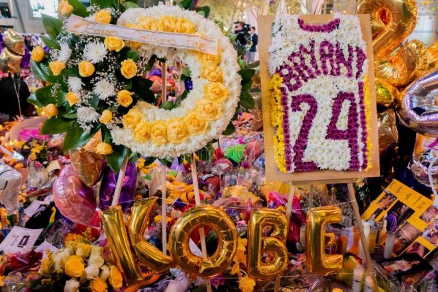 Kobe Bryant Helicopter Crash Memorial Empty Staples Center court lit in purple and gold with Bryant jerseys on every seat
