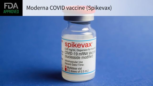 Moderna Spikevax Vaccine Vial A healthcare professional holds a Moderna COVID-19 vaccine vial and syringe in a clinical setting.