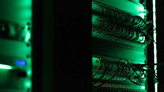 Musk's xAI Enters Crowded AI Sector with Abstract Universe-Comprehension Goal Elon Musk stands at a podium announcing xAI, with a cosmic backdrop symbolizing the company's mission to understand the universe.