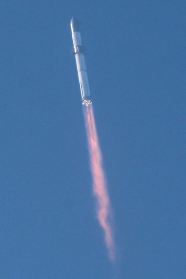 Starship flight test 1 Starship lifts off from Boca Chica, Super Heavy engines blazing in a cloud of dust and fire.
