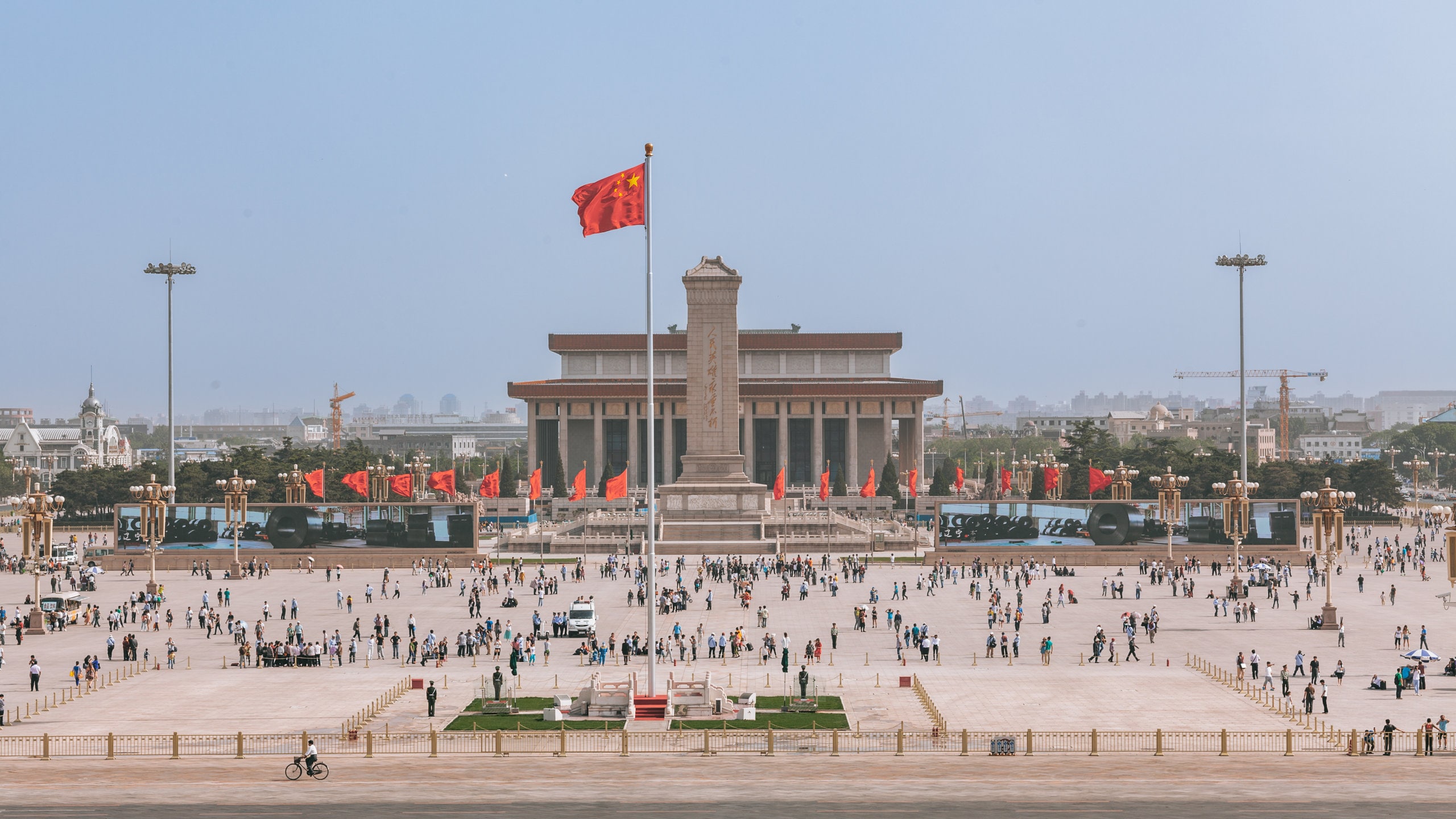 Tiananmen Square Beijing Chinese workers in face masks walk through a nearly empty city street during the coronavirus outbreak.