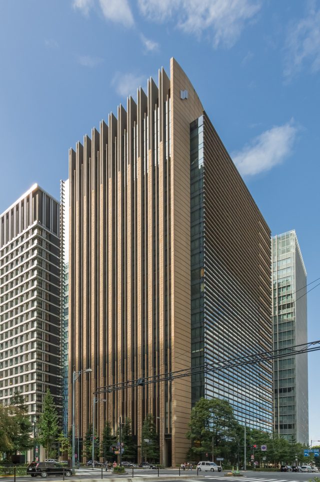 Tokyo Financial District Skyline Japanese Financial Services Agency officials review documents at a desk in a Tokyo office building.
