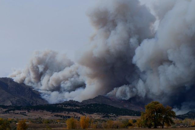 Edson and Yellowhead County evacuated as wildfire prompts highway closure Aerial view of a wildfire burning near a highway, with smoke rising over prairie landscape and vehicles evacuating west.
